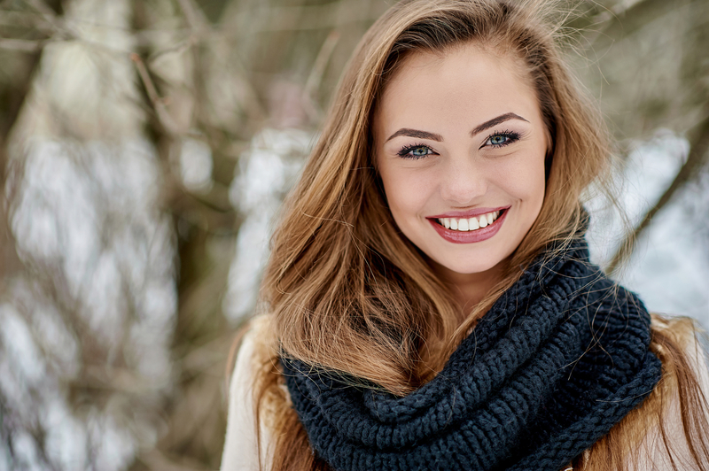 Beautiful young woman in winter park