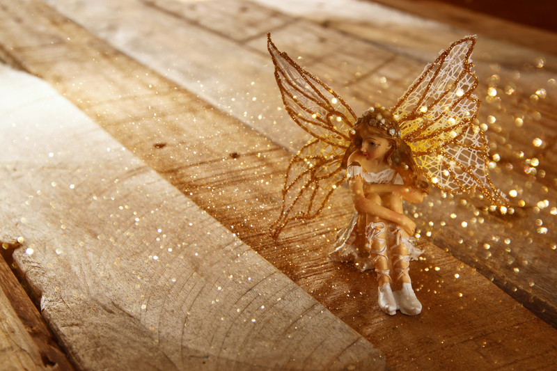 picture of a fairy sitting on wood